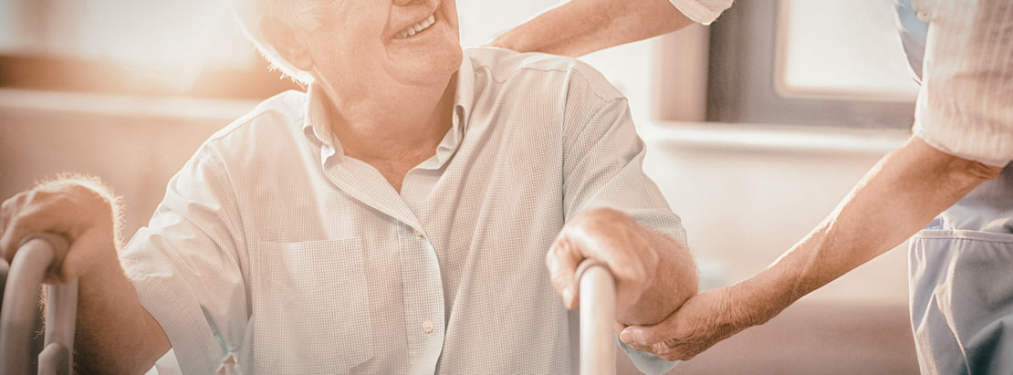 woman helping senior man walk